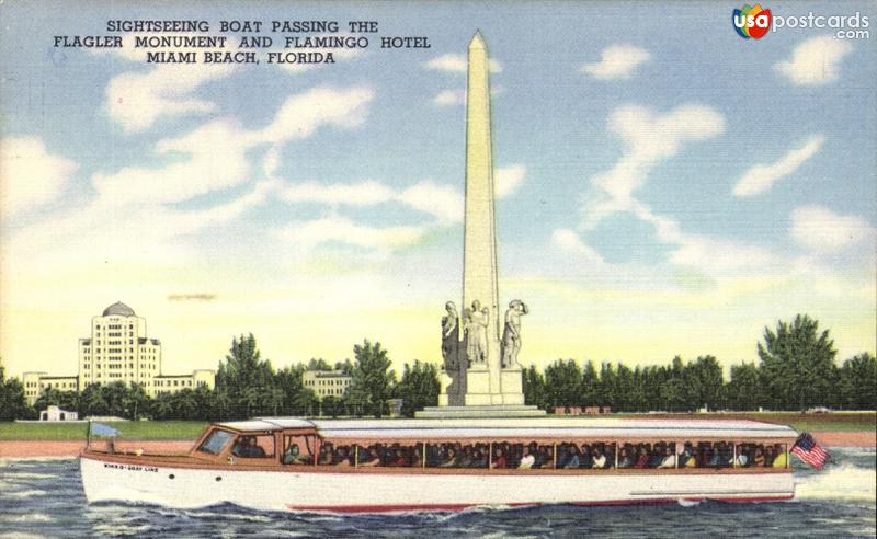 Sightseeing boat passing the Flagler Monument and Flamingo Hotel