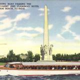 Sightseeing boat passing the Flagler Monument and Flamingo Hotel